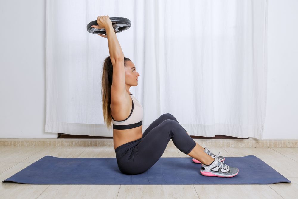 Woman doing workout with barbell
