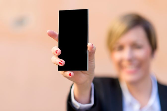 Woman showing her phone screen with selective focus