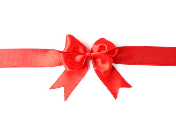 Red ribbon with bow isolated on blank background. Gift concept