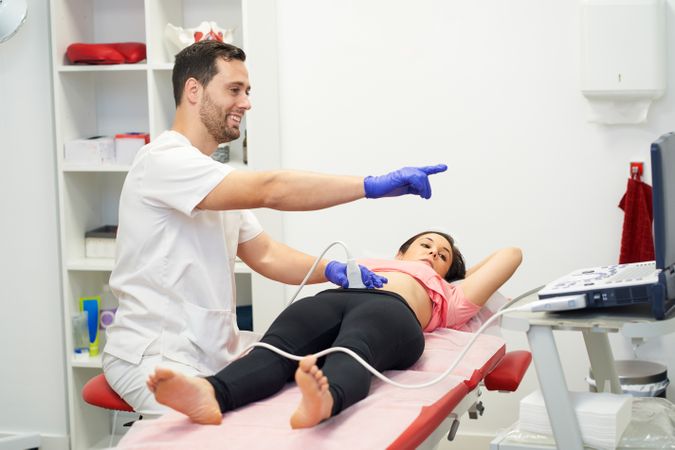 a physiotherapist performing an ultrasound scan for pelvic floor
