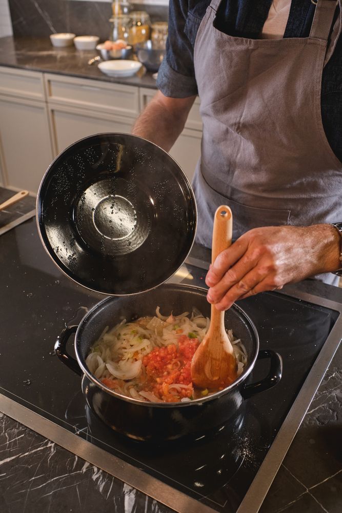 Unrecognizable male chef cooking dinner at home