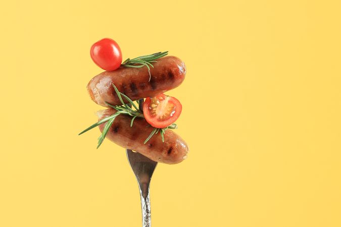 Roasted Sausages on Fork with Cherry Tomato and Rosemary