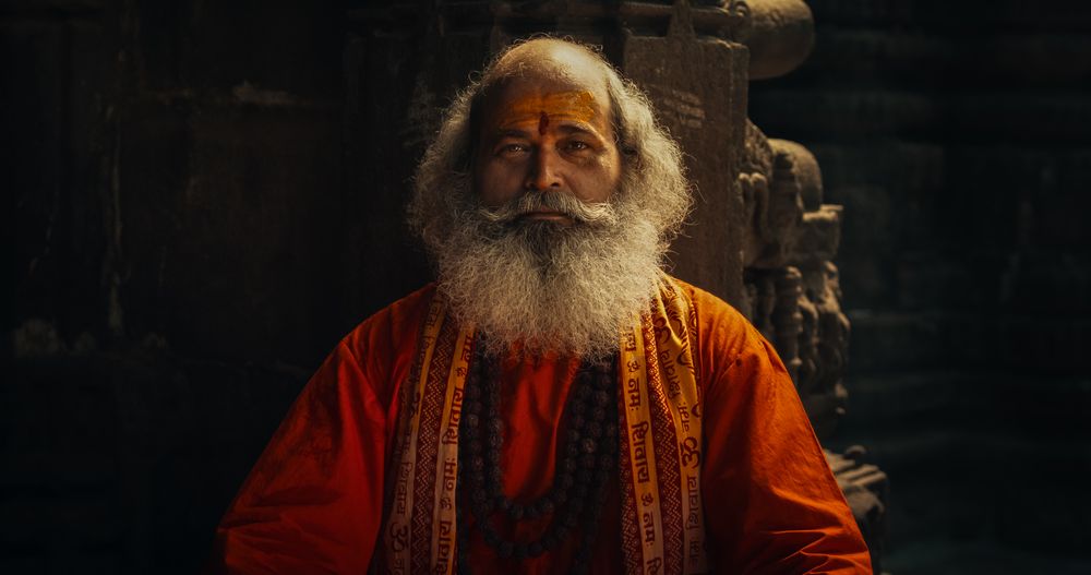 Authentic Shot of An Indian Mature Monk Blowing a Conch Shell in an Ancient Stone Temple.