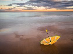 Umbrella on beach near sea