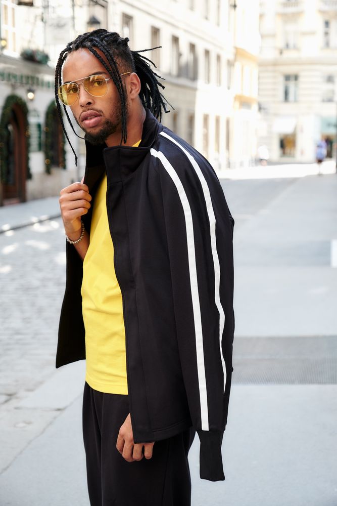 Black male standing with arms crossed
