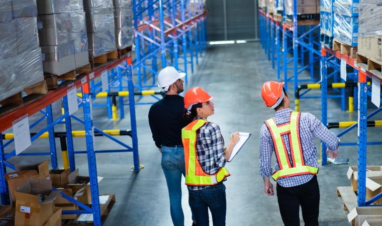 Multi-ethnic group of colleagues checking stock in the warehouse