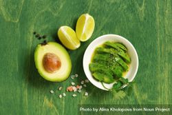 Avocado and lime on green table 5r83nb