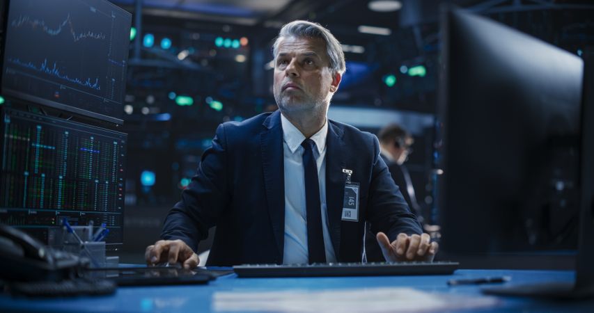 Portrait of a Man Working on the Floor in a Modern Stock Exchange Firm