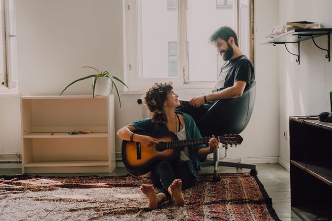 Cheerful couple spending time together at home