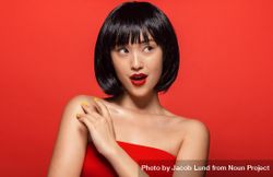 Stylish Korean female model against red background 0vylBb