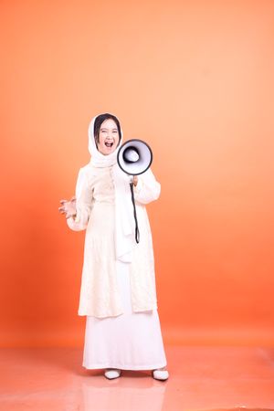 Passionate proclamation, Woman in hijab using megaphone to amplify