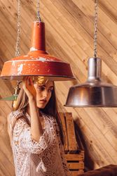 Young woman posing between ceiling lamps