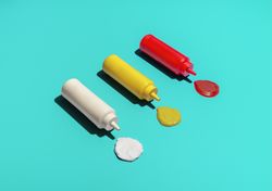 Sauce bottles above view, isolated on a blue background