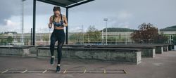 Sportswoman jumping on an agility ladder