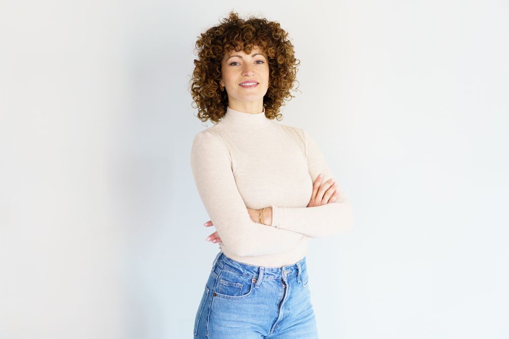 Happy woman in casual clothes with arms crossed