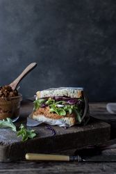Sandwich with vegetables and dry tomatoes pate on tray