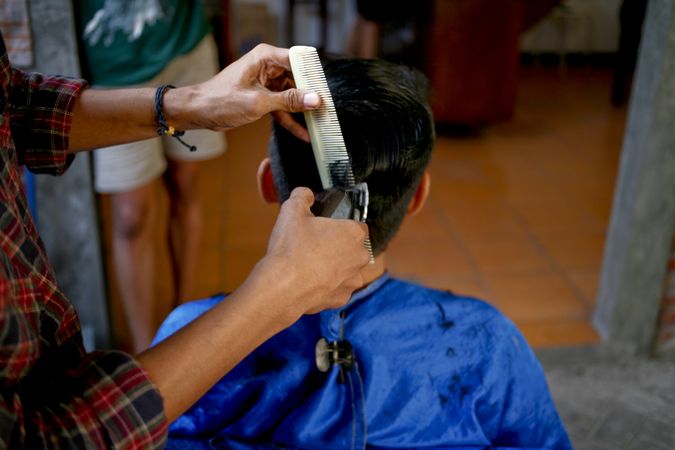 Young man having his hair cut