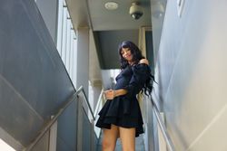 Woman in cute summer dress dancing on stairs