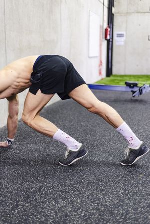 Man doing handstand in gym