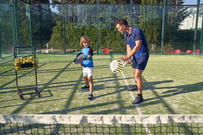 Coach explaining hitting technique to boy