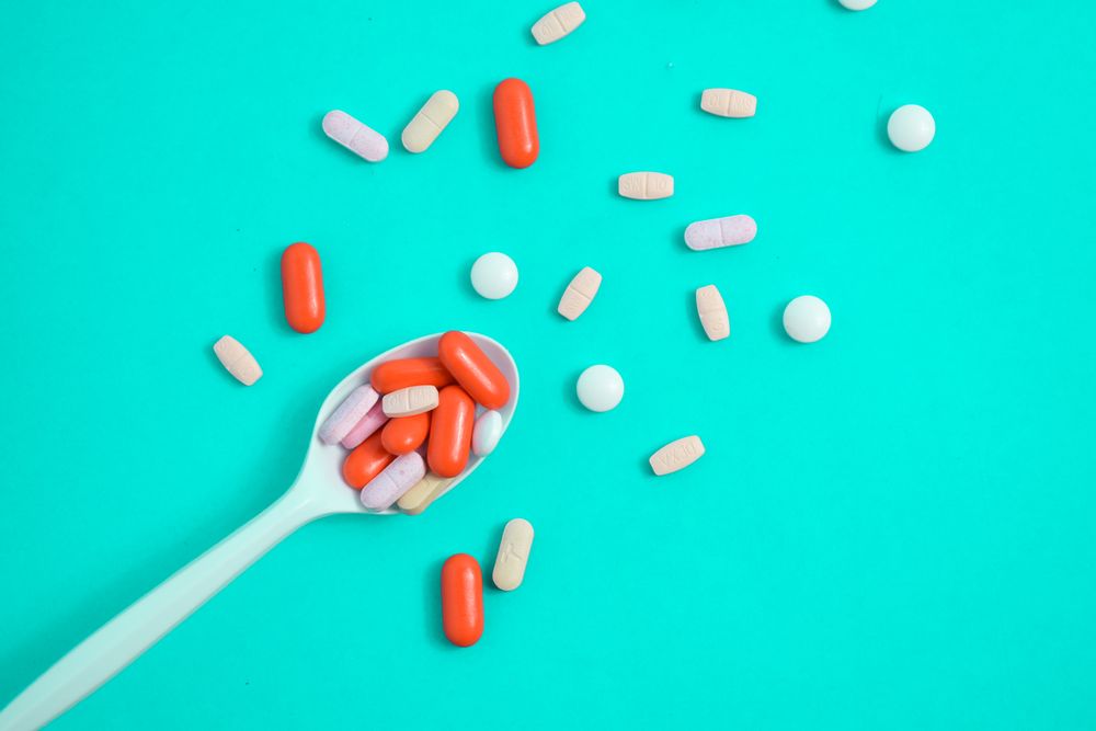 Plastic spoon with a variety of colorful tablets