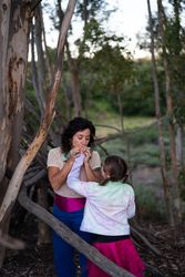 Mother consoling her daughter with a kiss on her hand