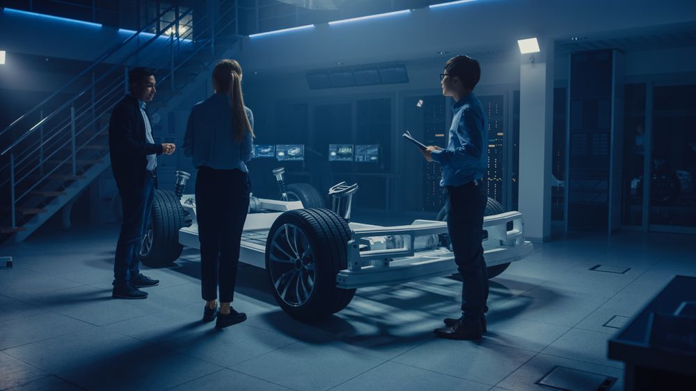 Team of Automobile Design Engineers in Automotive Innovation Facility Working on Electric Car