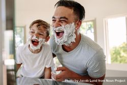 Father and son having fun while shaving in bathroom 0LVqV4