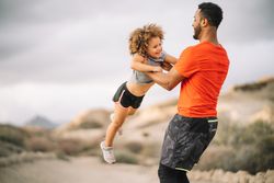 Black father holding child in arms