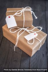 Two presents wrapped in natural paper with twine on wood table 4N16A5
