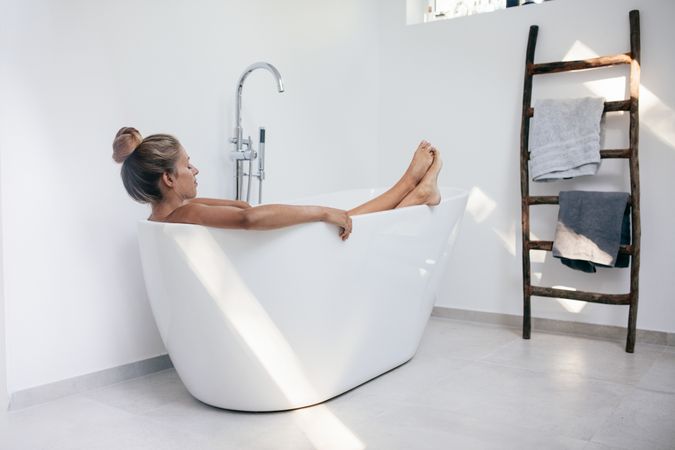 Young woman relaxing in bathtub