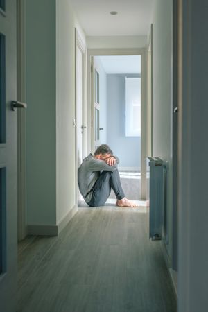 Man crying in hallway