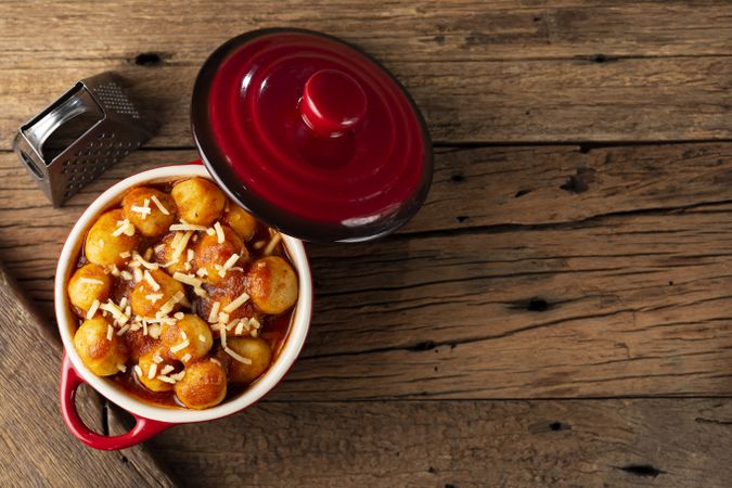 Gnocchi with tomato sauce and grated Parmesan cheese.