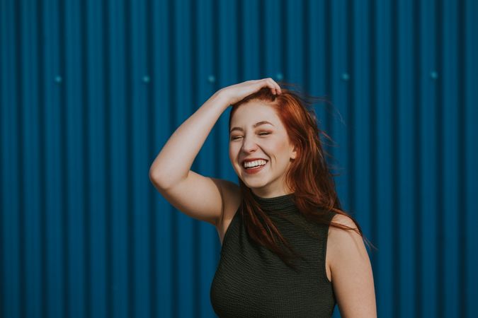 Smiling woman squinting in sun and enjoying weather