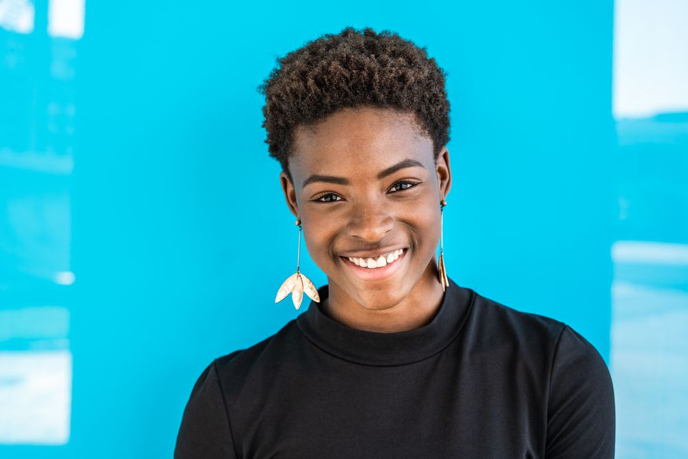 Black woman standing on blue background