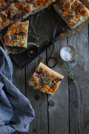 top view of Pieces of fresh focaccia on wooden table