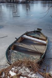 Boat frozen in ice on lake
