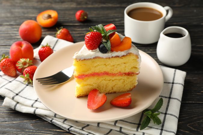 Composition with delicious berry cream cake on wooden table. Tasty dessert