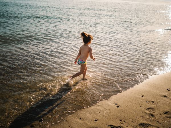 Anonymous girl running on seaside