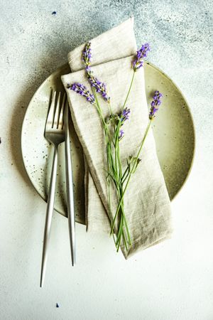 Top view of delicate summer table setting with lavender flowers