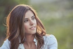 Dreamy woman sitting in nature
