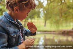 Small kid admiring an insect in his fingers 5qzjE4