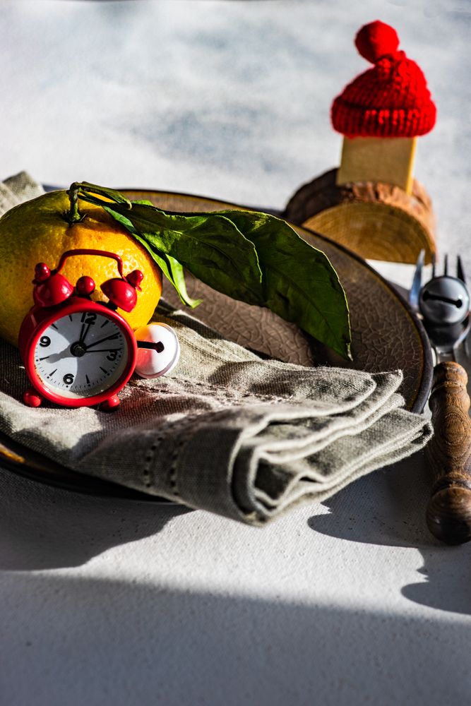 Wintry table setting with tangerine and Santa hat decoration