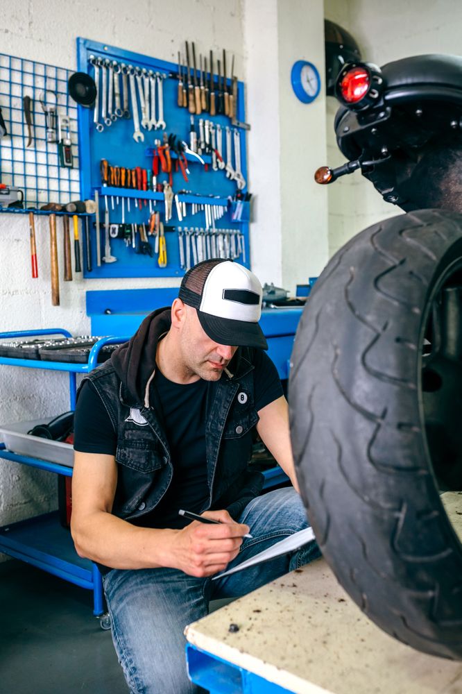 Mechanic checking motorcycle