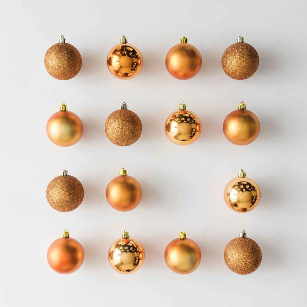Golden Christmas baubles decoration on light background