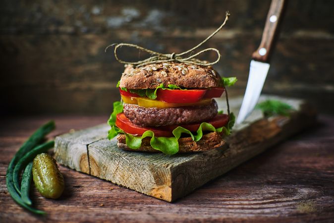Delicious burger on wooden board