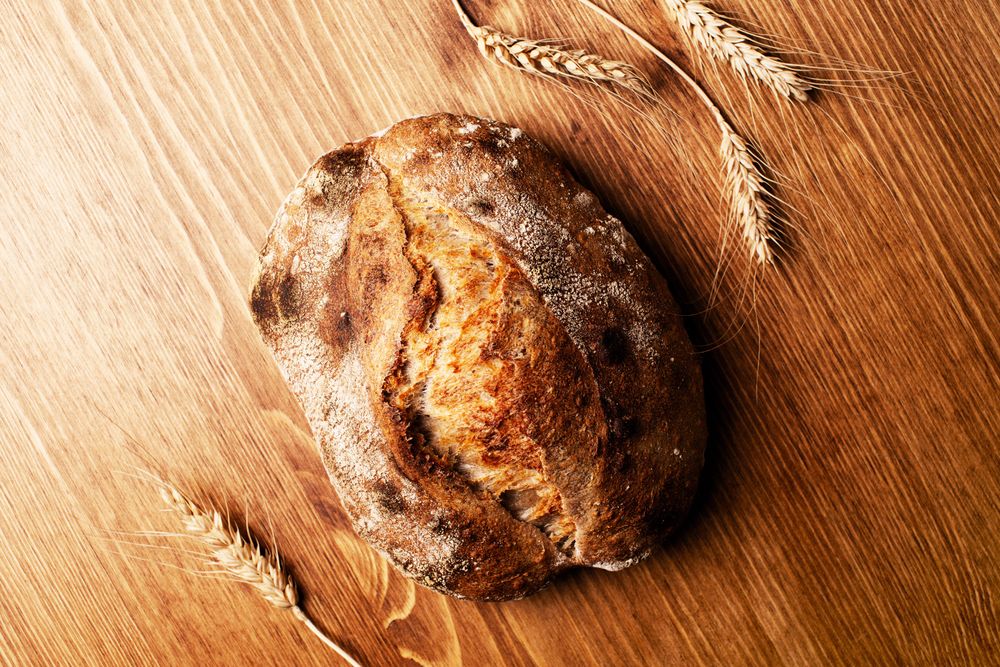 Top view of round loaf of bread with wheat chaff