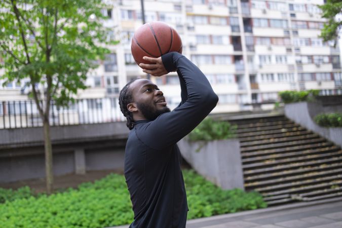 Black Male Athlete Shooting Hoops.