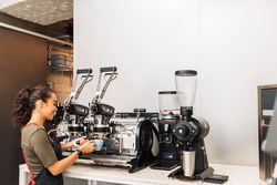 Woman in apron preparing coffee