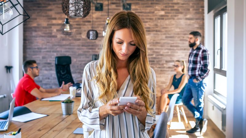 Portrait of businesswoman looking mobile in the office